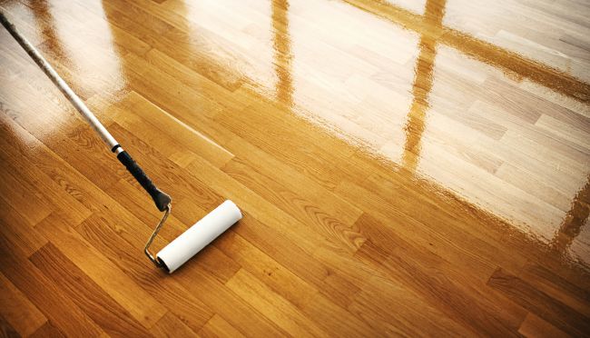 paint roller over a hardwood floor